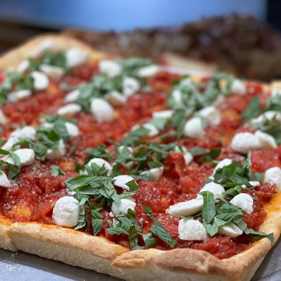 Times Square Kitchen's rectangular pizza with chunky tomato sauce, fresh mozzarella, and basil.